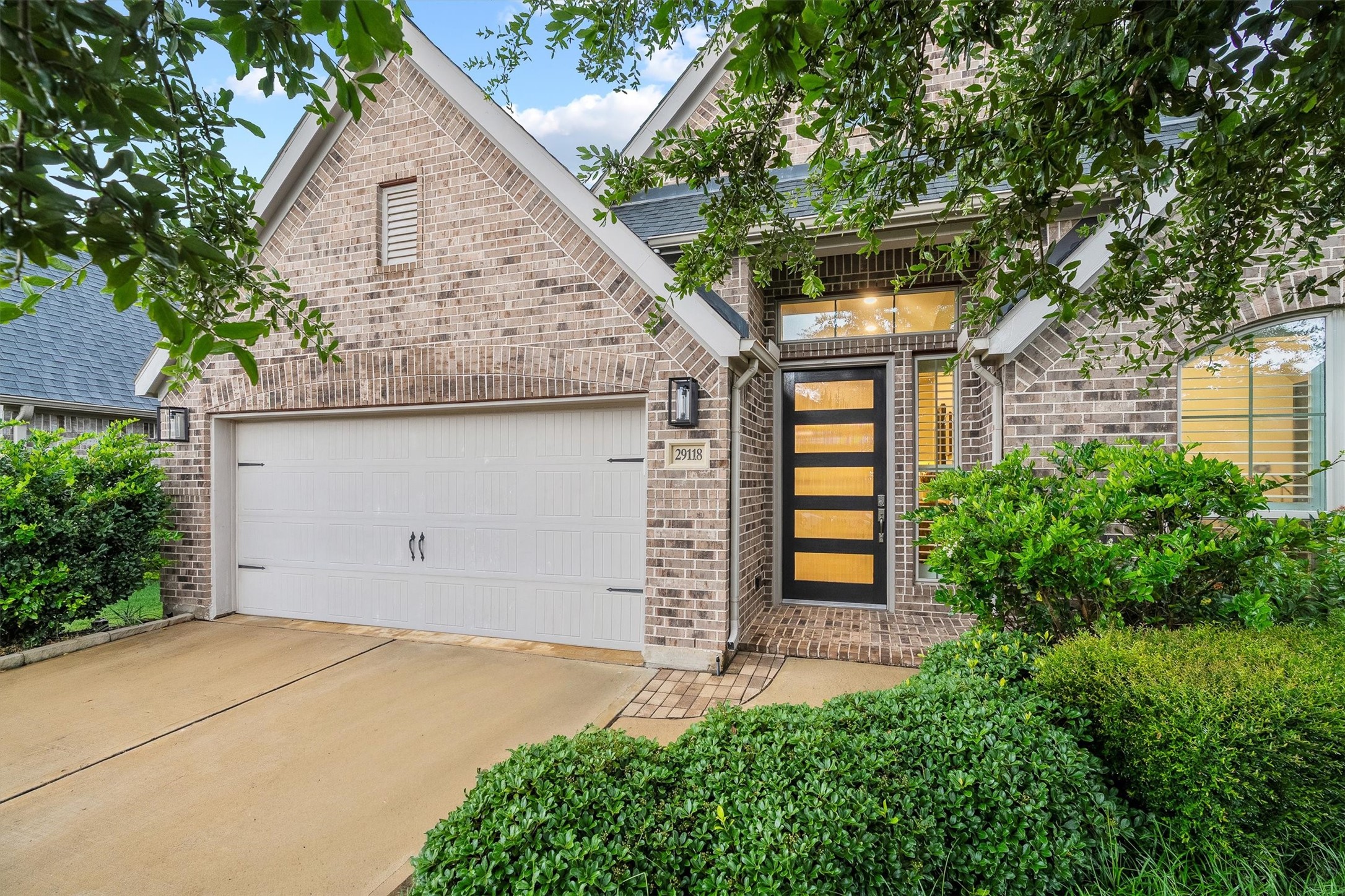 29118 Lantana Ridge Court Fulshear, TX 77441 - Photo 2 of 29 This beautifully designed Perry home offers a brick elevation, clean architectural lines, mature landscaping, and a warm, inviting presence that truly stands out.