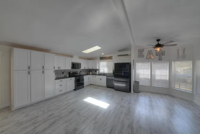 a kitchen with a refrigerator and a stove top oven