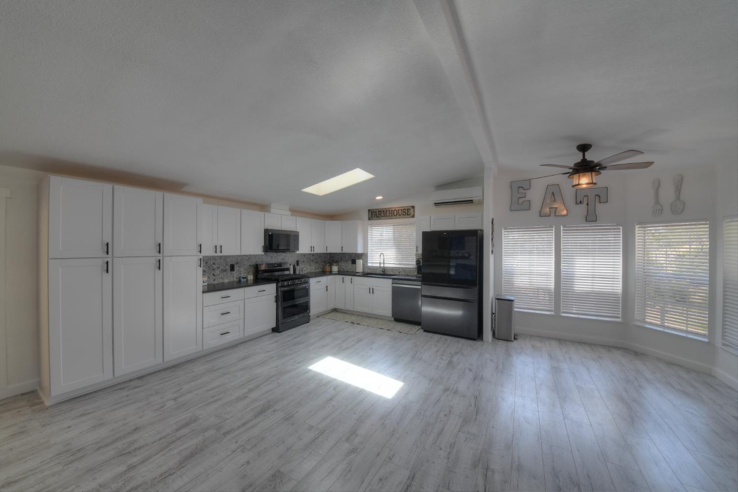 17045 Table Mountain Road Jamestown, CA 95327 - Photo 11 of 59 a kitchen with a refrigerator and a stove top oven