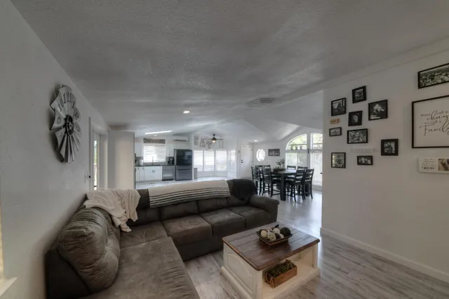 a living room with furniture and a wooden floor