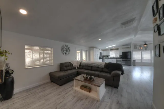 a living room with furniture and a wooden floor