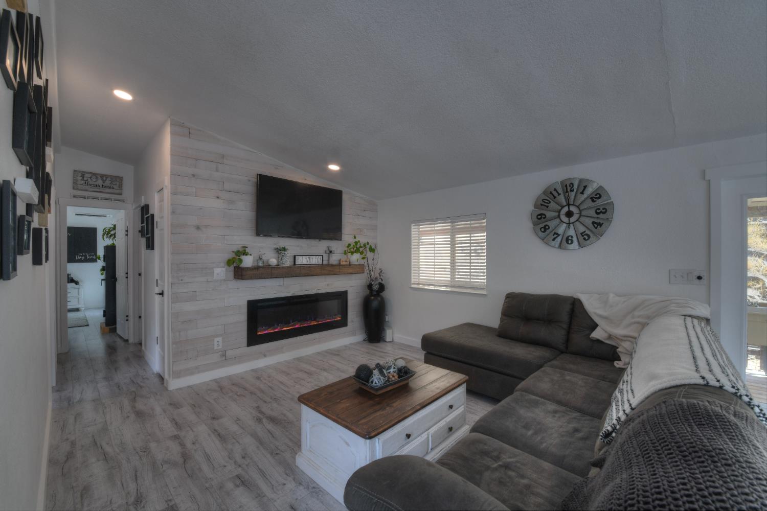 17045 Table Mountain Road Jamestown, CA 95327 - Photo 20 of 59 a living room with furniture a fireplace and a flat screen tv