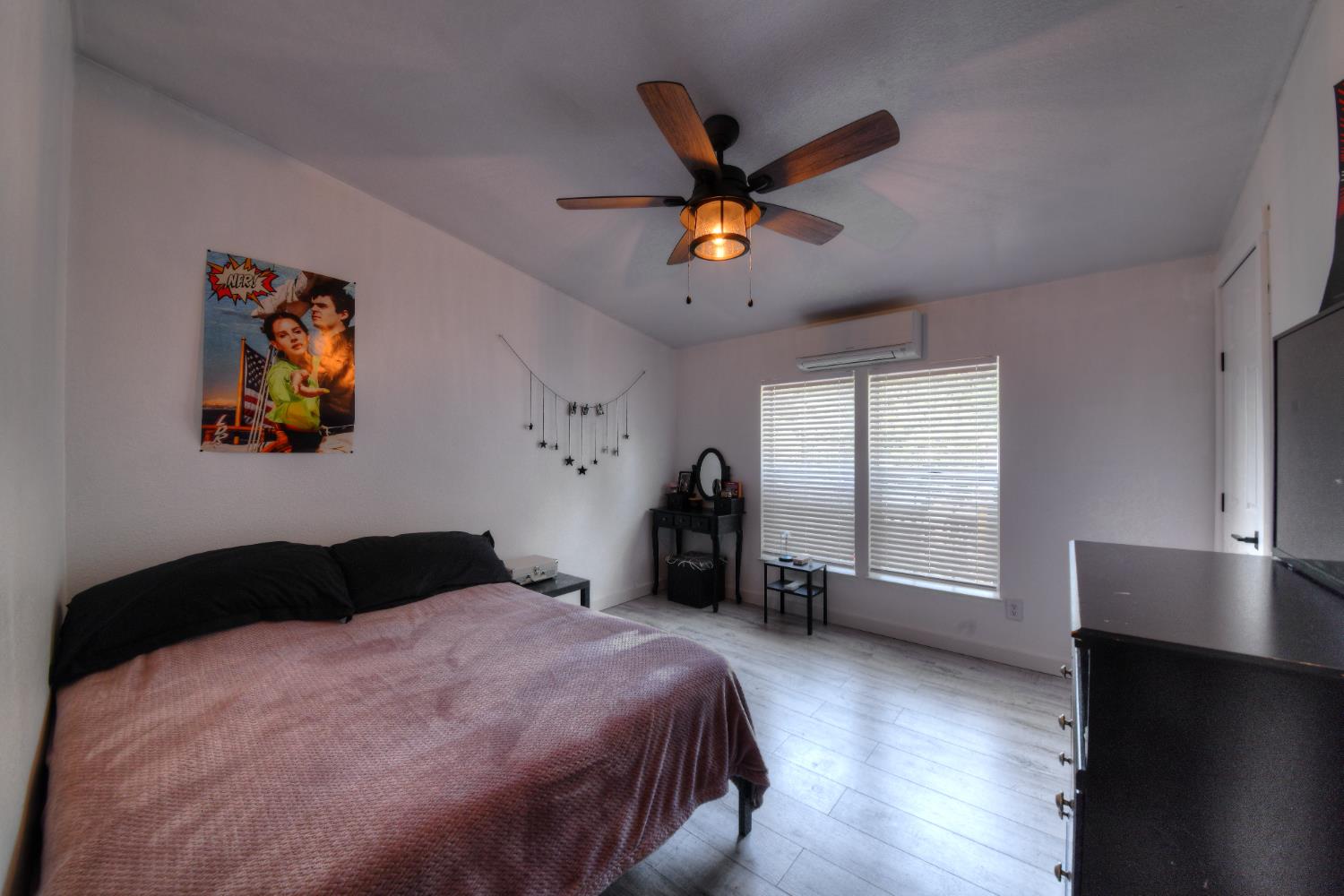 17045 Table Mountain Road Jamestown, CA 95327 - Photo 21 of 59 a bedroom with a bed and a chandelier