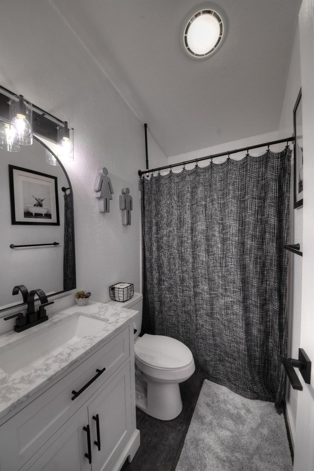 17045 Table Mountain Road Jamestown, CA 95327 - Photo 22 of 59 a bathroom with a granite countertop sink toilet and shower