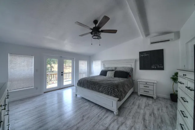 a living room with a bed furniture and a flat screen tv