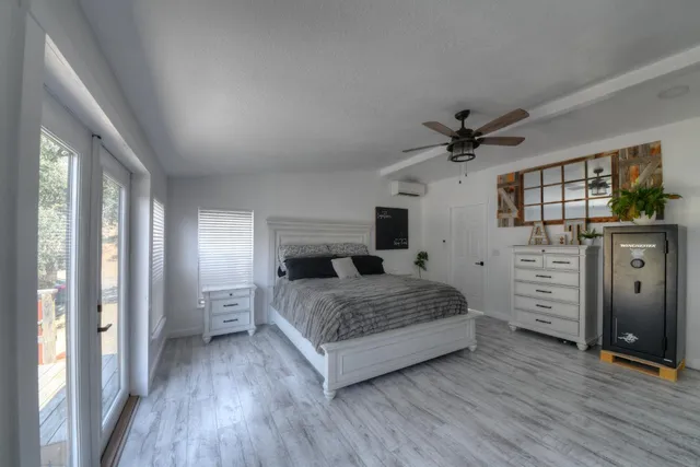 a bedroom with a bed and a flat tv screen