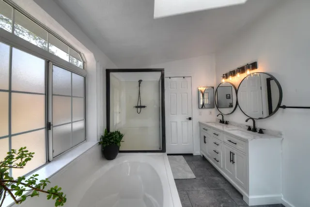 a spacious bathroom with a bathtub and a shower