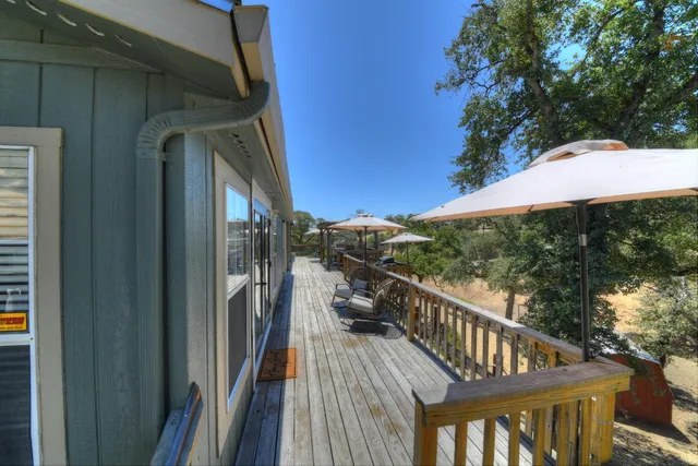 a view of balcony with wooden floor and barbeque oven