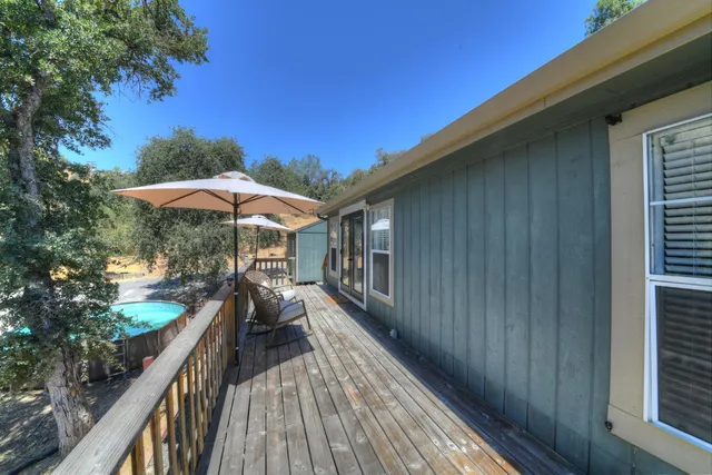 a view of a house with wooden deck