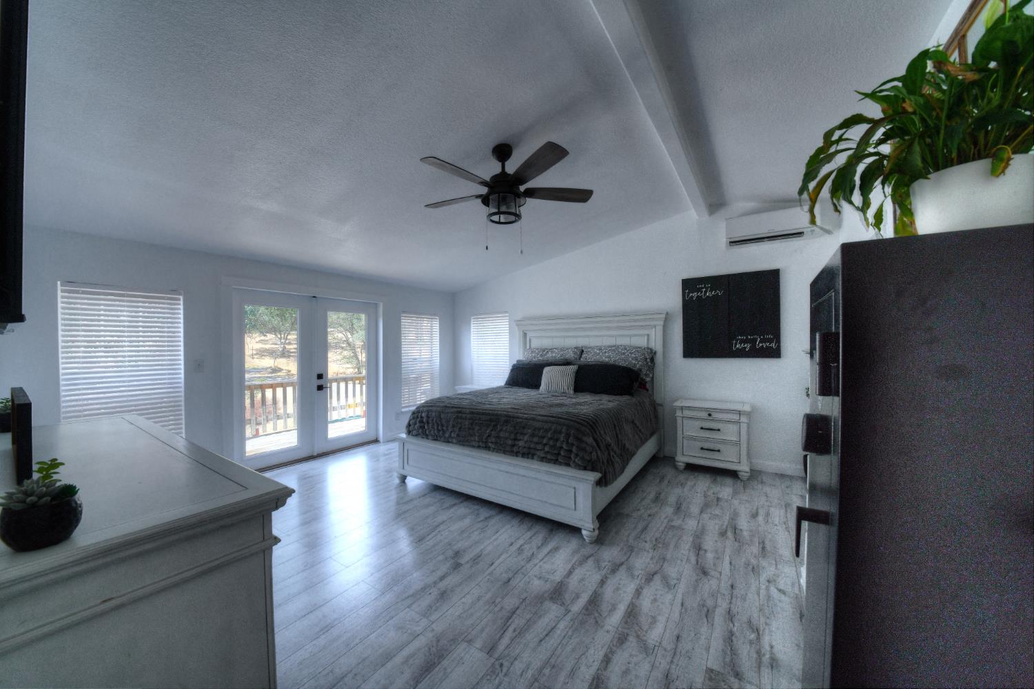 17045 Table Mountain Road Jamestown, CA 95327 - Photo 4 of 59 a bedroom with a bed and a potted plant on the dresser