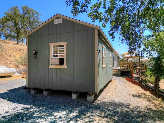 a kitchen with a sink cabinets and wooden floor