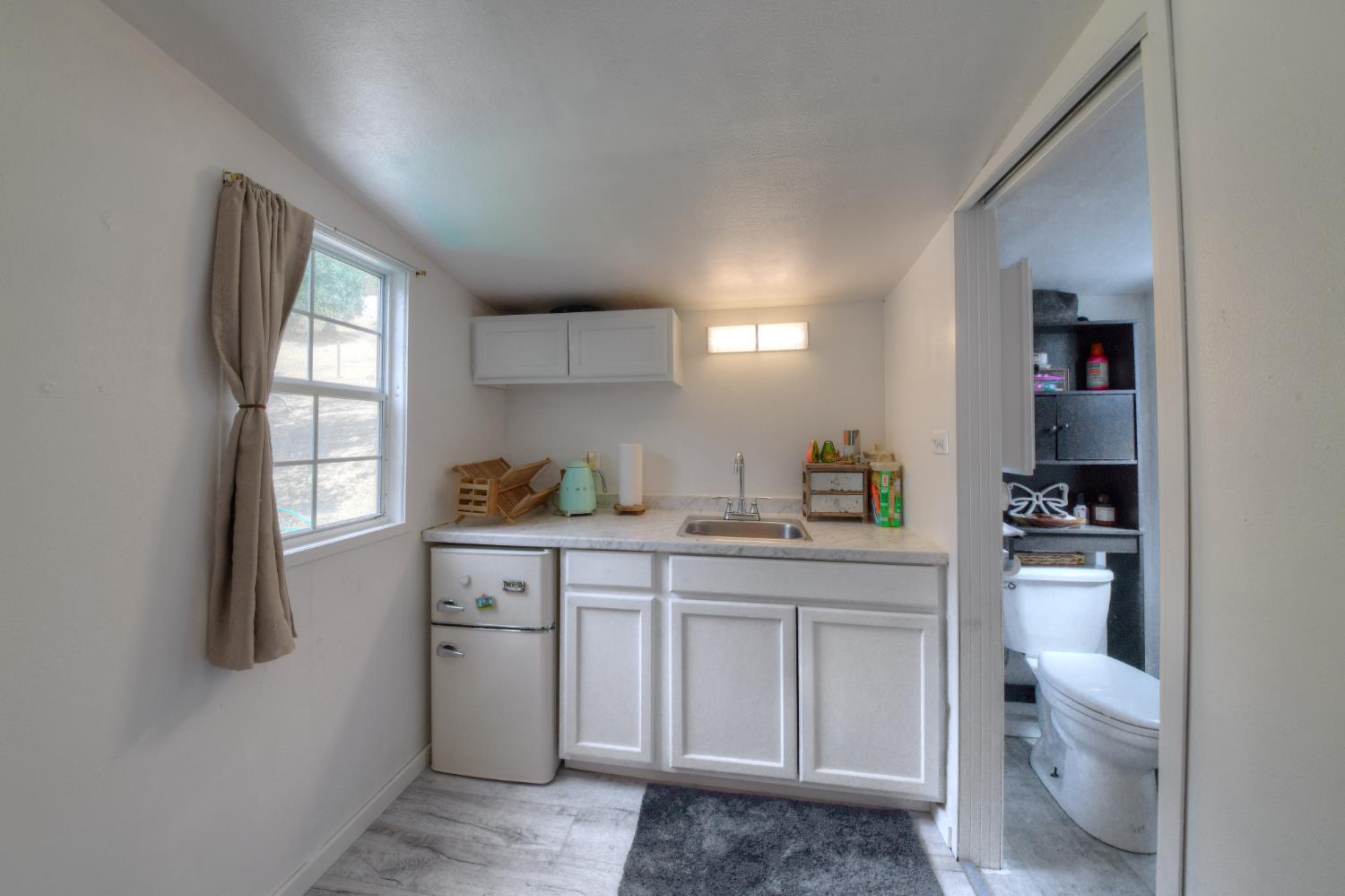 17045 Table Mountain Road Jamestown, CA 95327 - Photo 46 of 59 a kitchen with a sink cabinets and wooden floor
