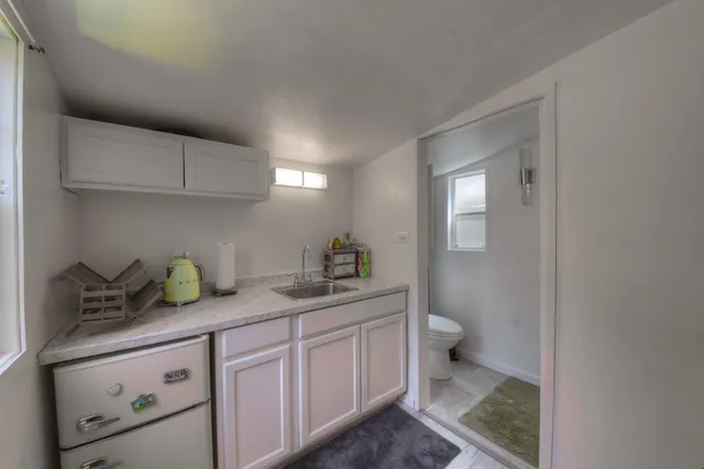 an aerial view of a house with swimming pool and sitting area