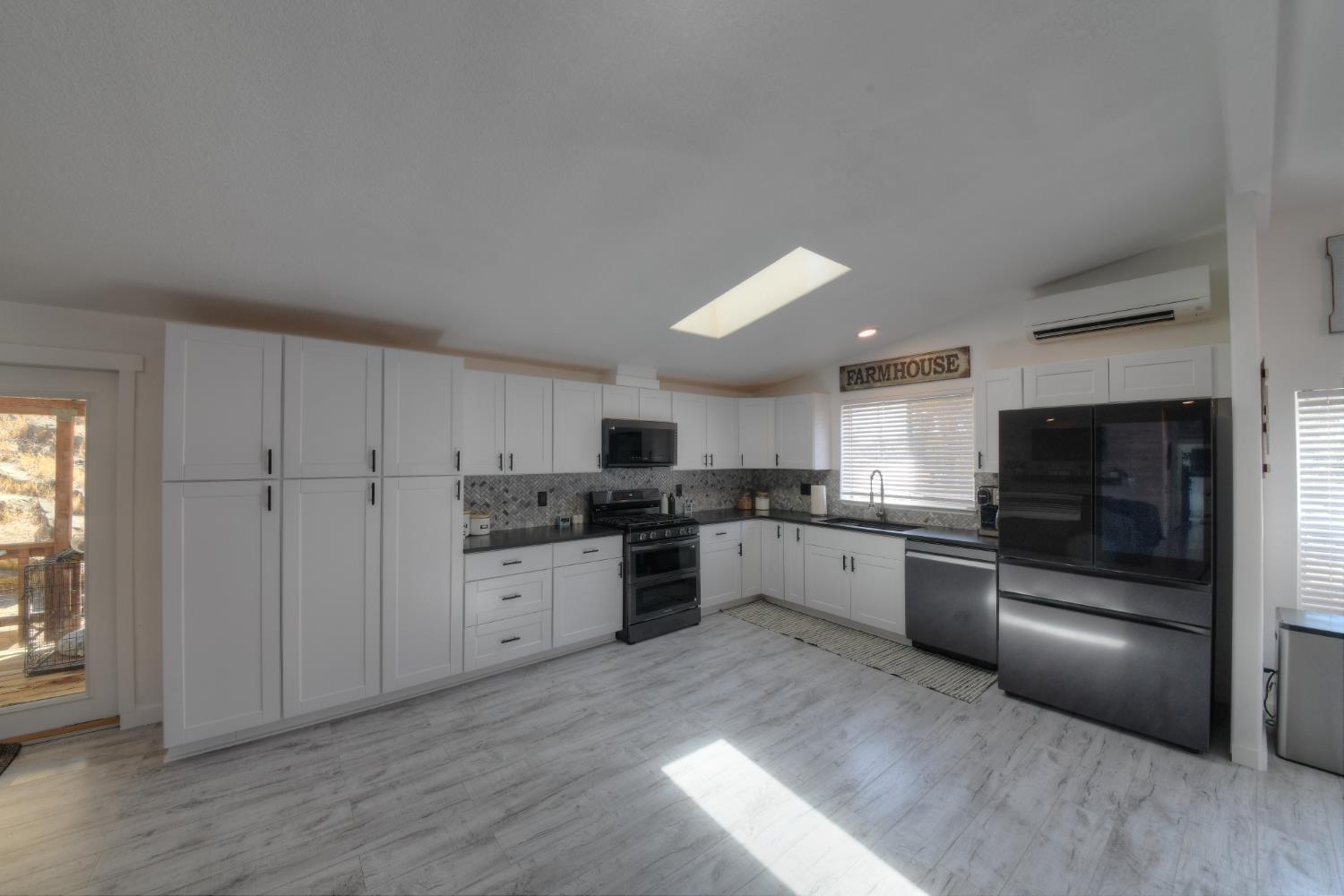 17045 Table Mountain Road Jamestown, CA 95327 - Photo 10 of 59 a large kitchen with cabinets and stainless steel appliances