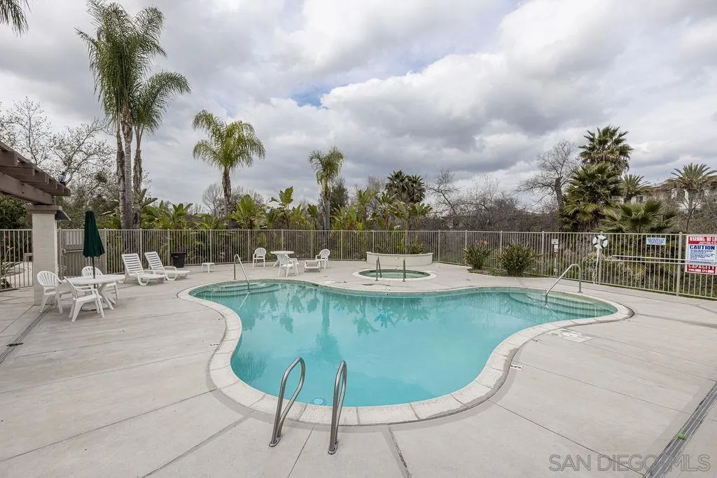 5527 Old Ranch Road, Unit 44 Oceanside, CA 92057 - Photo 30 of 34 a view of a swimming pool with a lounge chair and palm trees