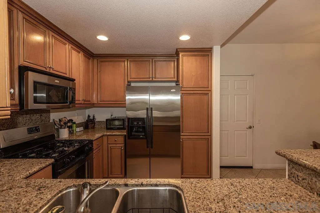 5527 Old Ranch Road, Unit 44 Oceanside, CA 92057 - Photo 9 of 34 a kitchen with a refrigerator stove and microwave