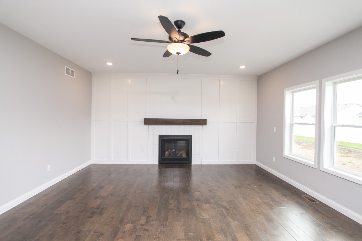 511 Bobwhite Way Normal, IL 61761 - Photo 15 of 39 an empty room with wooden floor a ceiling fan and windows