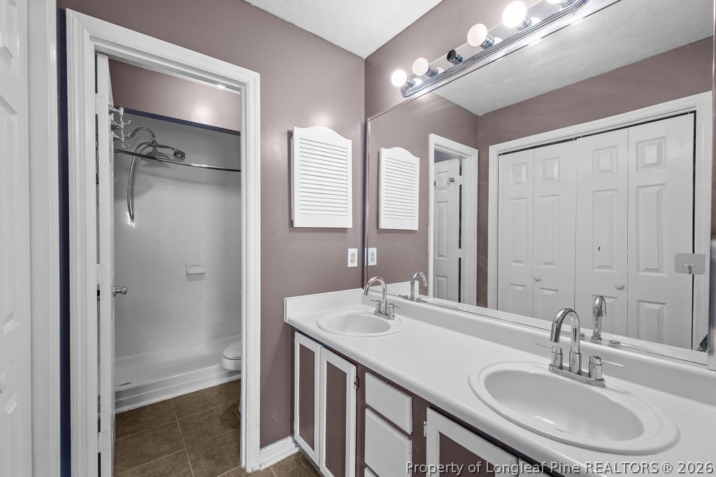 3446 Legion Road Hope Mills, NC 28348 - Photo 11 of 22 a bathroom with a sink double vanity and a mirror