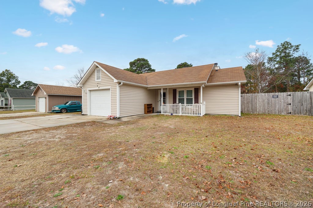 3446 Legion Road Hope Mills, NC 28348 - Photo 2 of 22 a front view of a house with a yard and garage