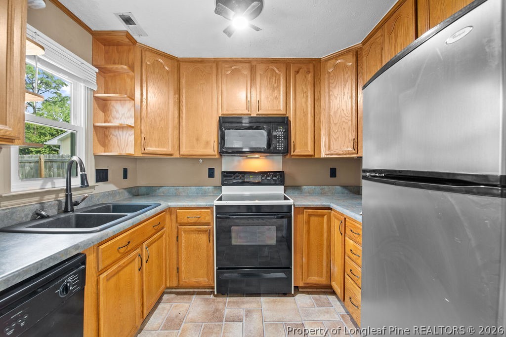 3446 Legion Road Hope Mills, NC 28348 - Photo 6 of 22 a kitchen with a sink stove and cabinets