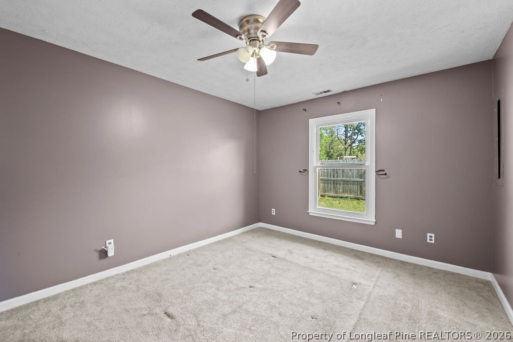 3446 Legion Road Hope Mills, NC 28348 - Photo 8 of 22 an empty room with a window and a fan