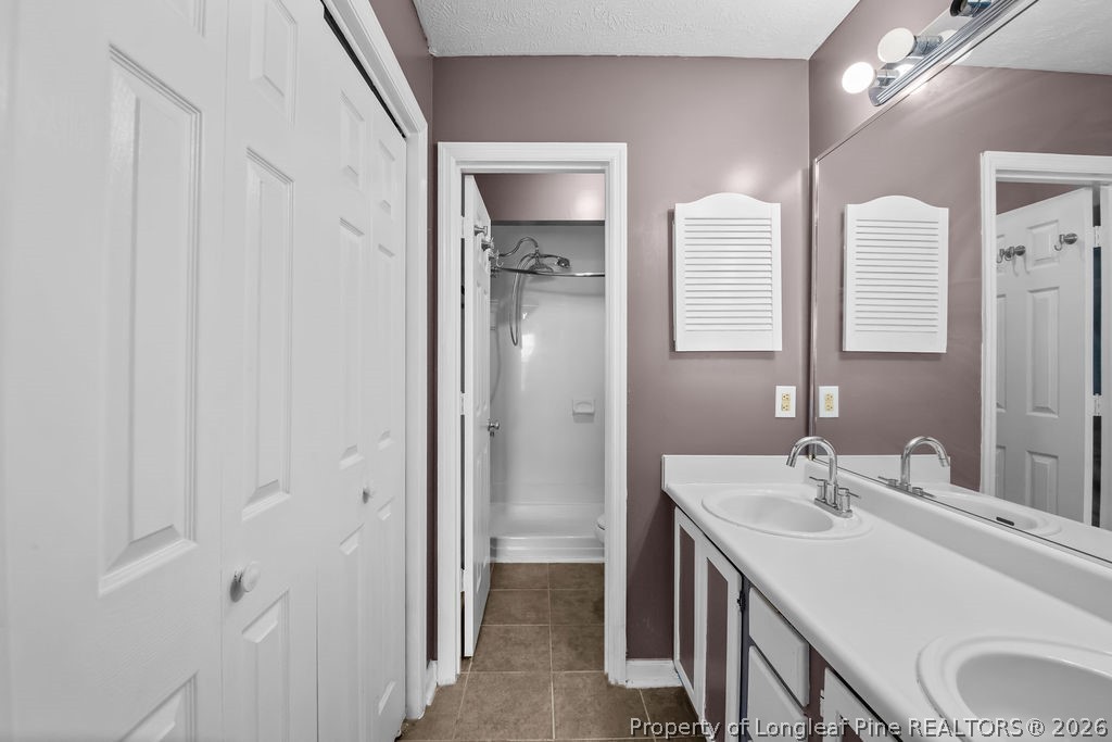 3446 Legion Road Hope Mills, NC 28348 - Photo 10 of 22 a bathroom with a sink a toilet and shower
