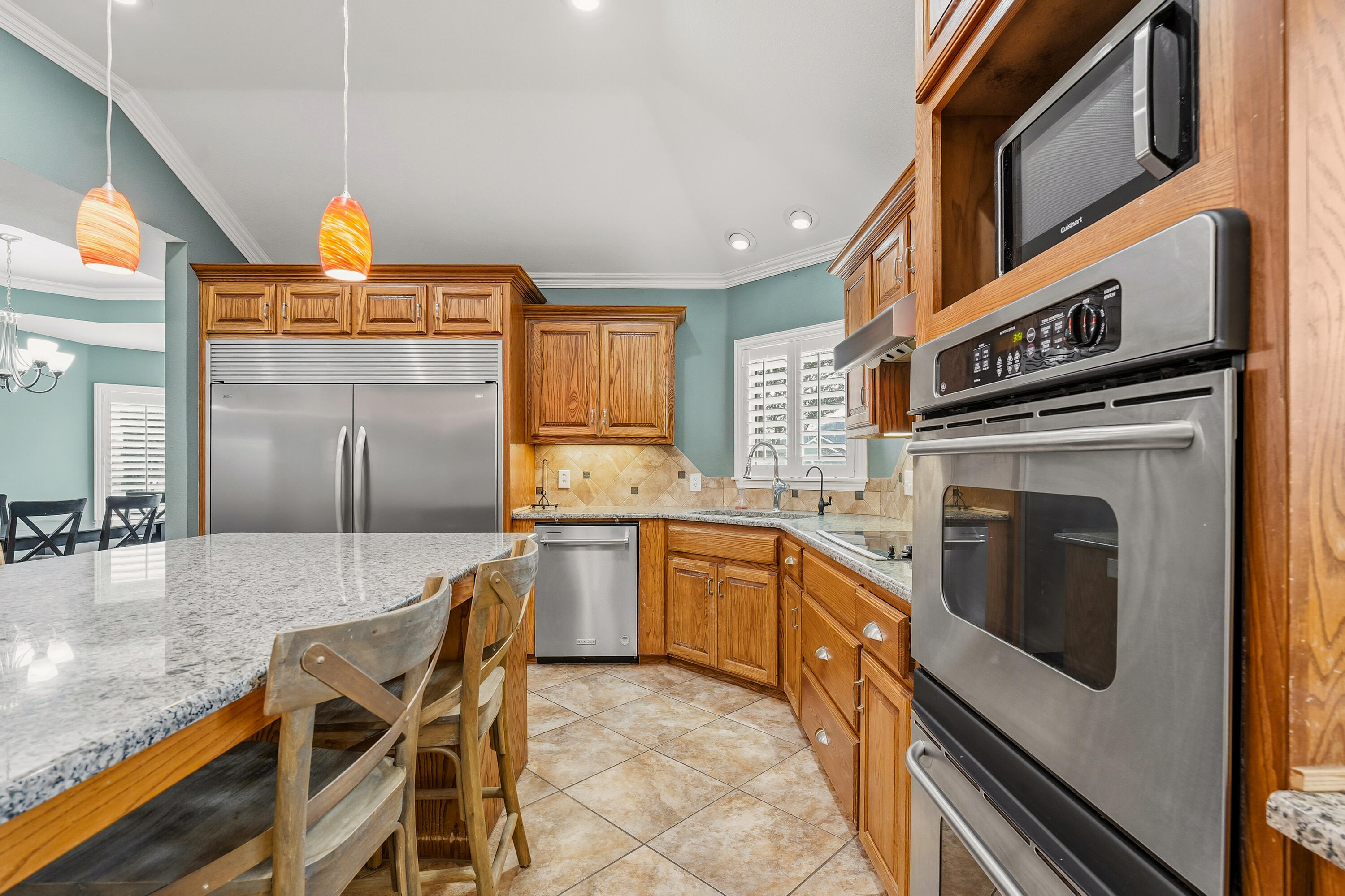 6903 87th Street Lubbock, TX 79424 - Photo 11 of 35 a kitchen with a stove a sink and a refrigerator