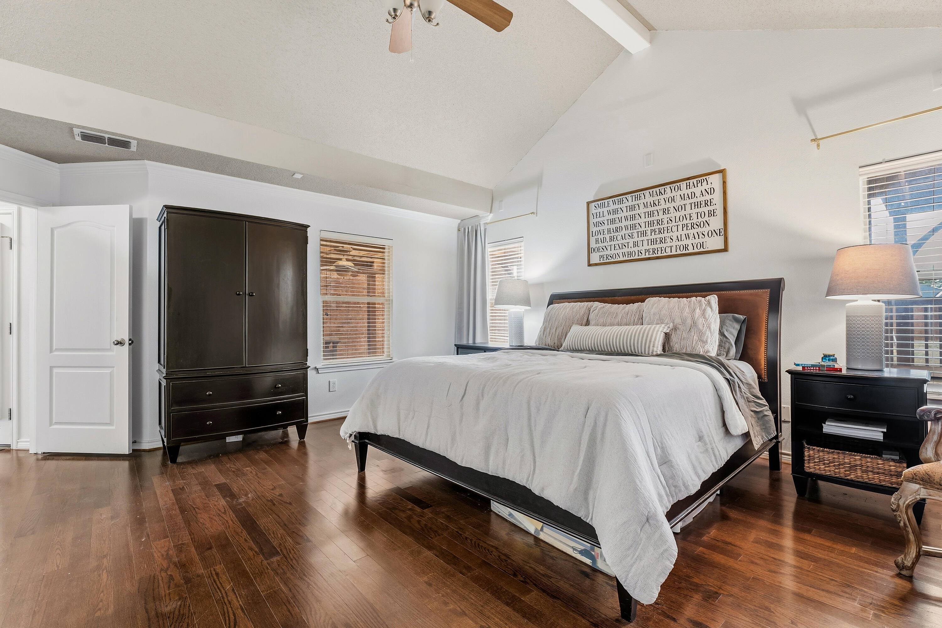 6903 87th Street Lubbock, TX 79424 - Photo 14 of 35 a bedroom with a bed and wooden floor