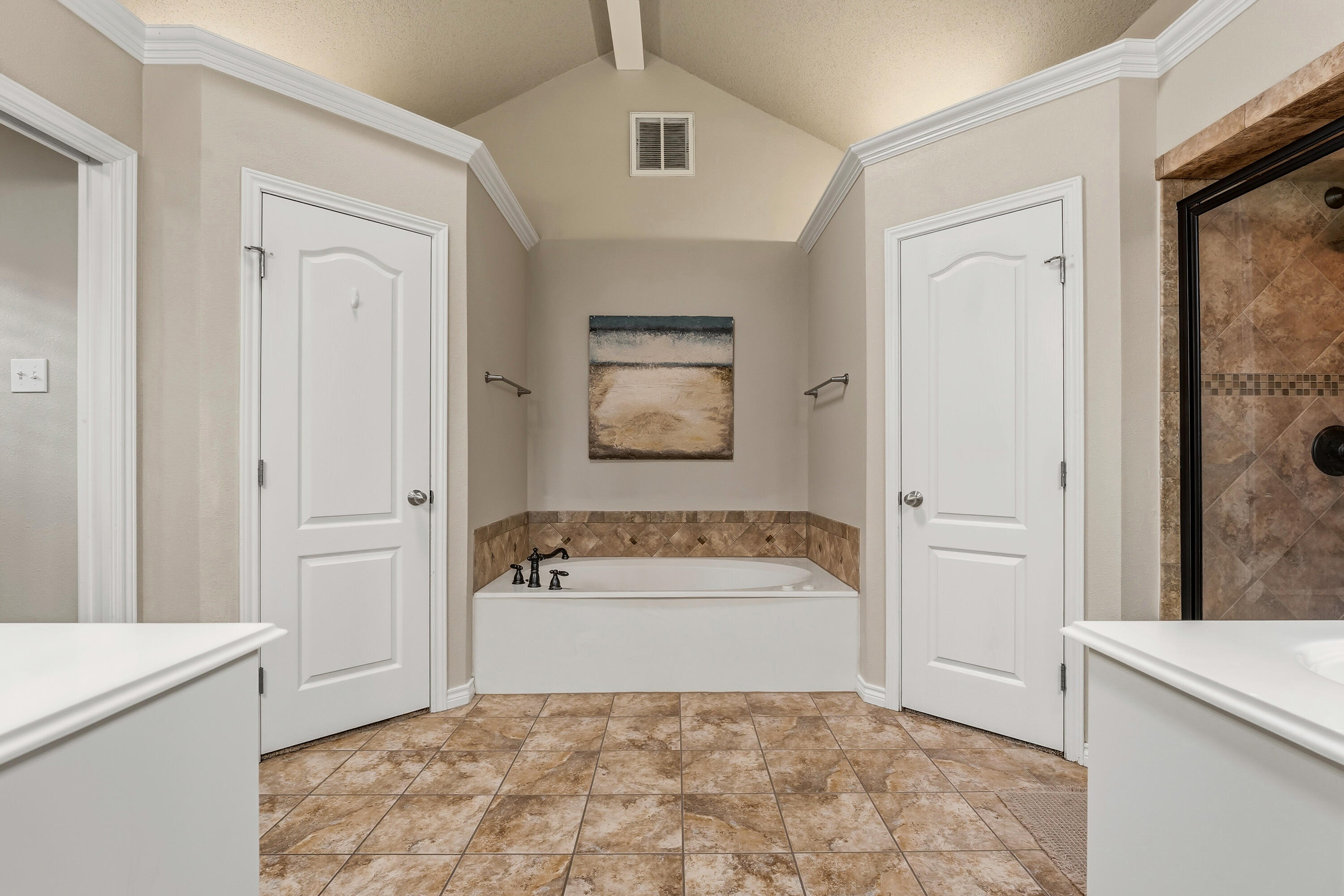 6903 87th Street Lubbock, TX 79424 - Photo 16 of 35 a bathroom with a tub sink and mirror