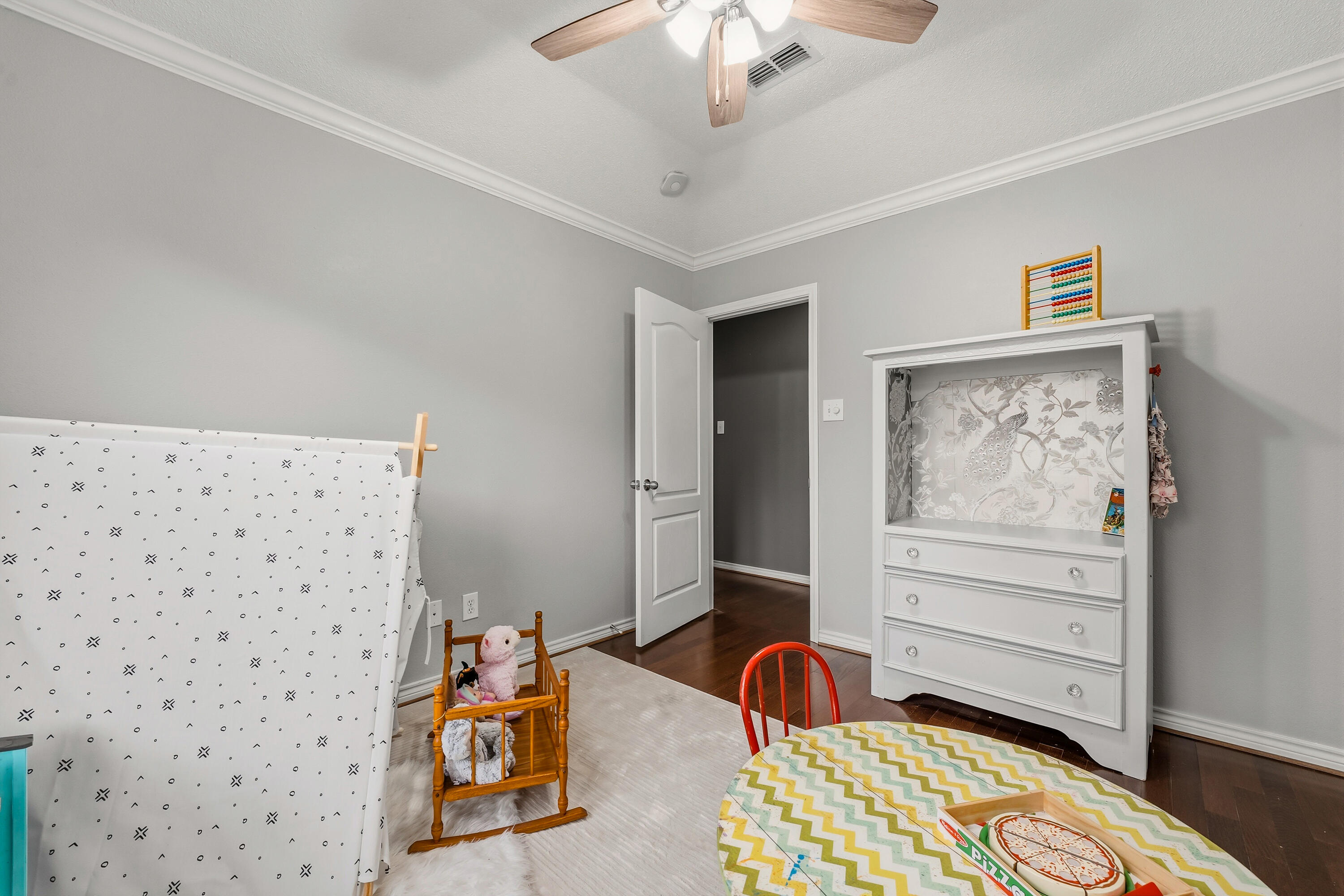 6903 87th Street Lubbock, TX 79424 - Photo 19 of 35 a bedroom with a bed and wooden floor