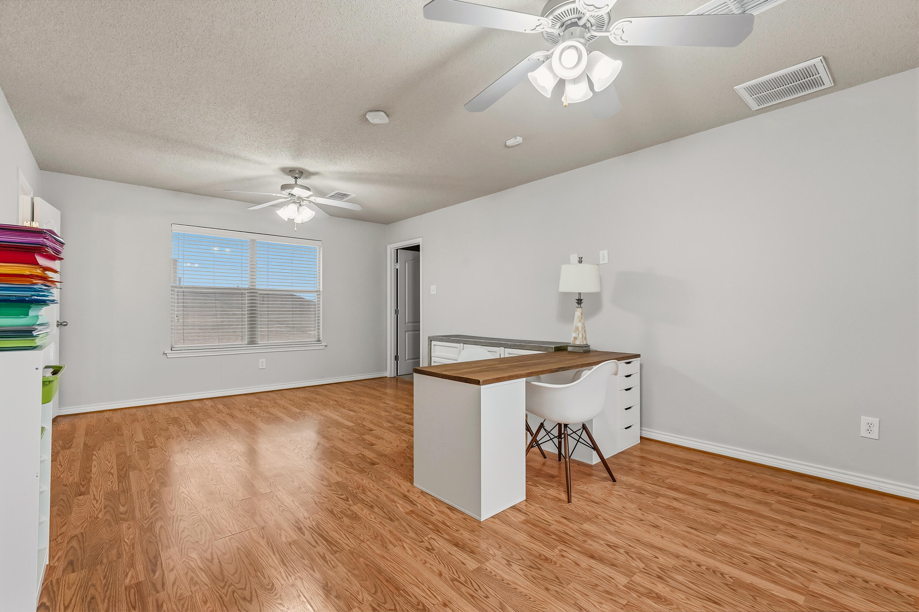 6903 87th Street Lubbock, TX 79424 - Photo 25 of 35 a room with furniture and a wooden floor