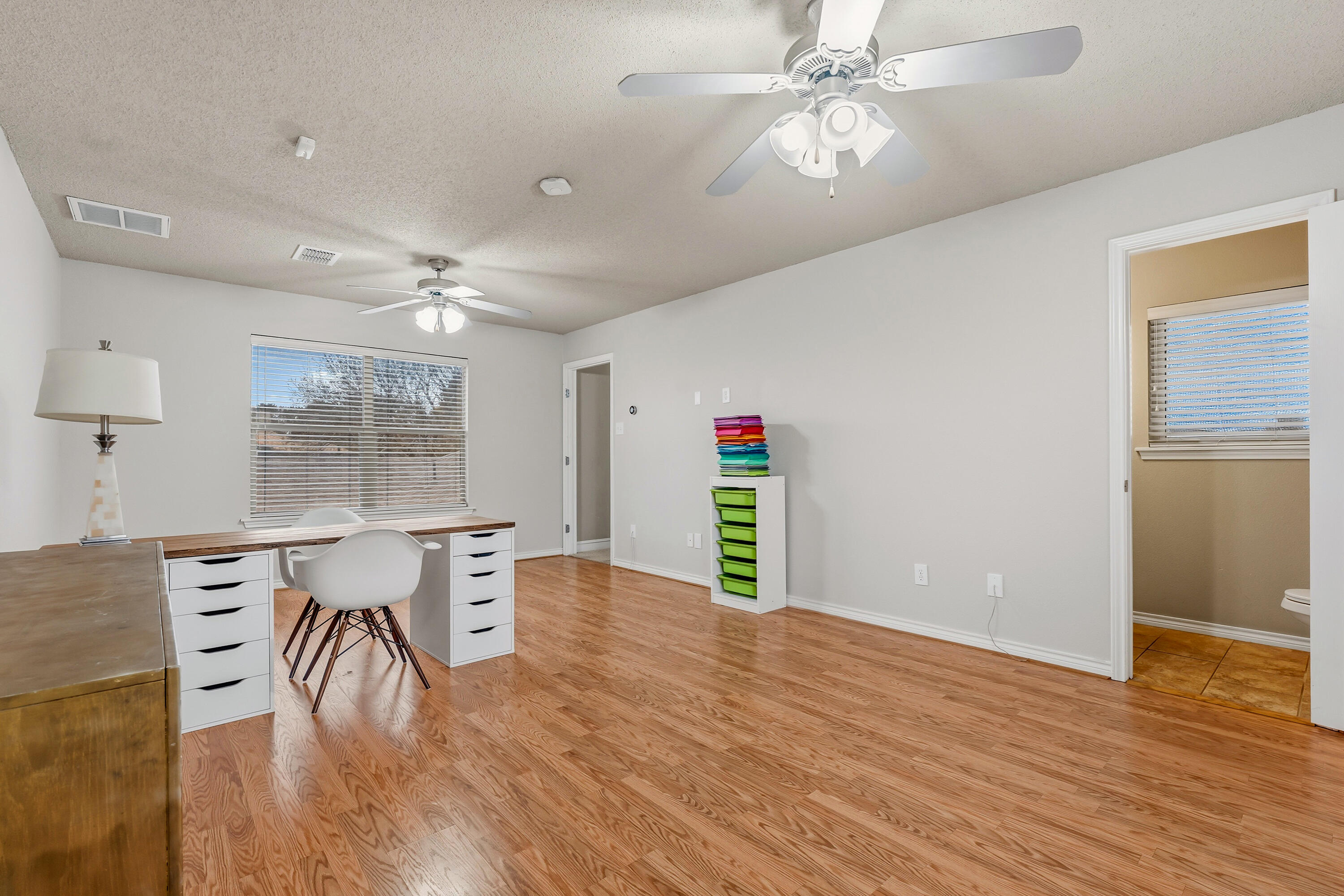 6903 87th Street Lubbock, TX 79424 - Photo 26 of 35 a view of a dining room with furniture and wooden floor