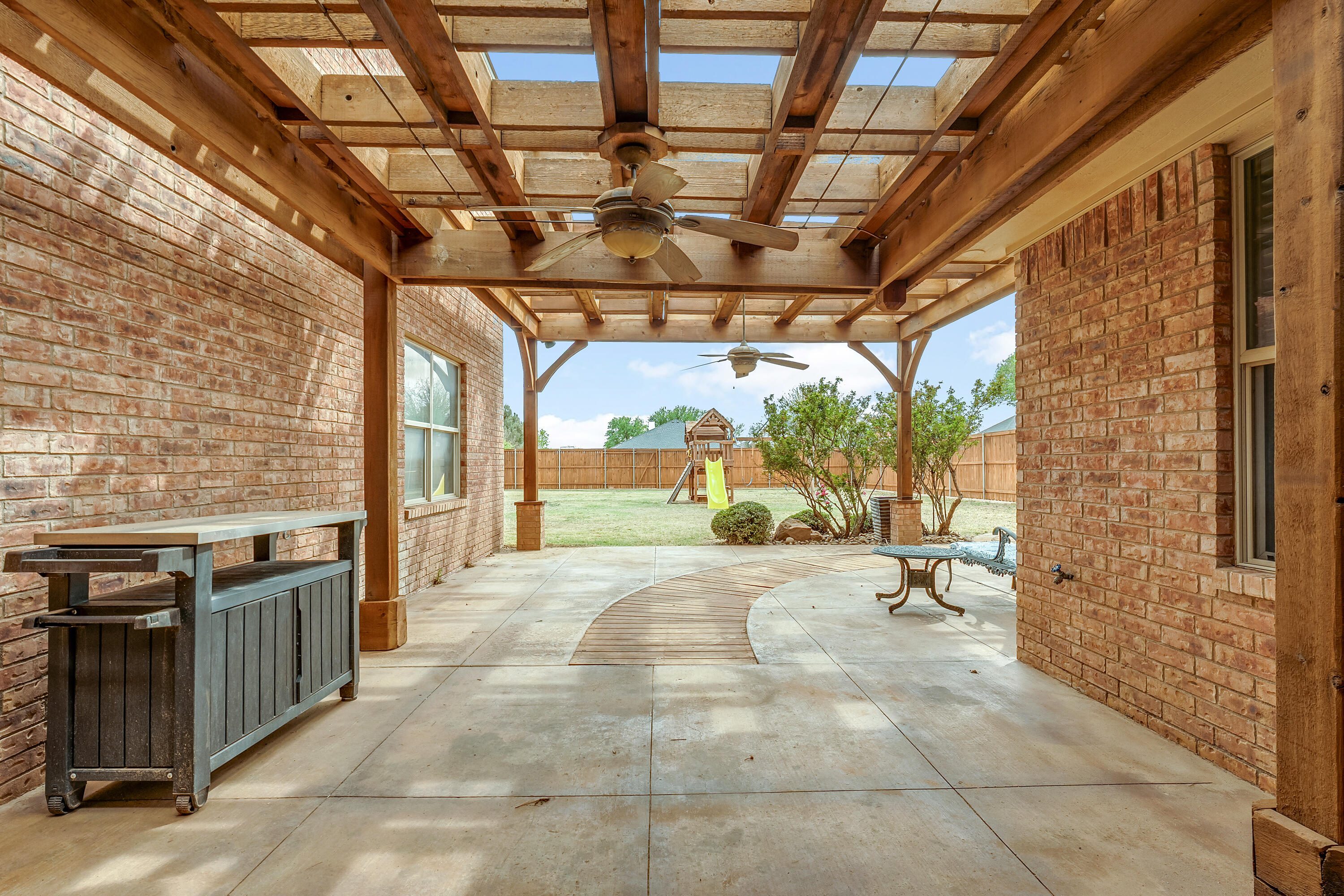 6903 87th Street Lubbock, TX 79424 - Photo 30 of 35 a view of a porch with a table and chairs