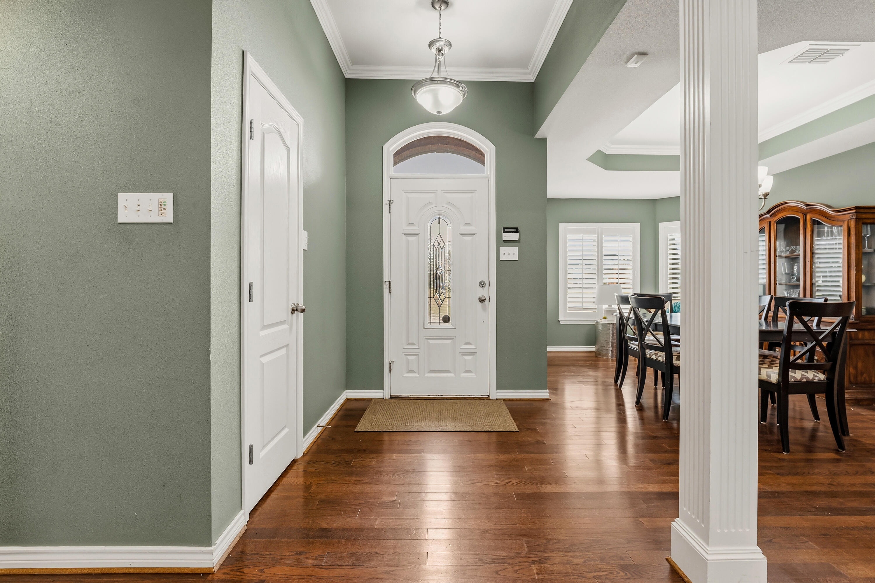 6903 87th Street Lubbock, TX 79424 - Photo 3 of 35 a view of a hallway with wooden floor windows and a living room