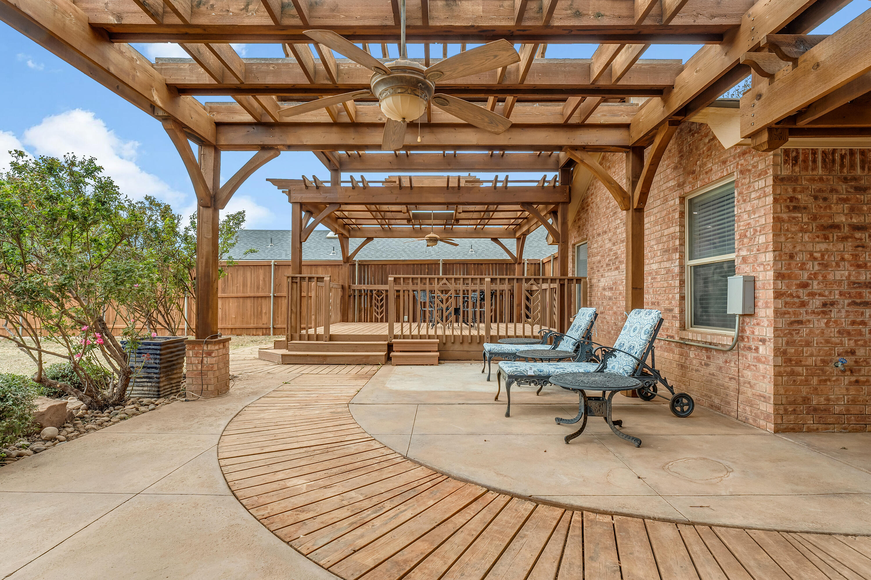 6903 87th Street Lubbock, TX 79424 - Photo 31 of 35 a building outdoor space with patio furniture and wooden floor