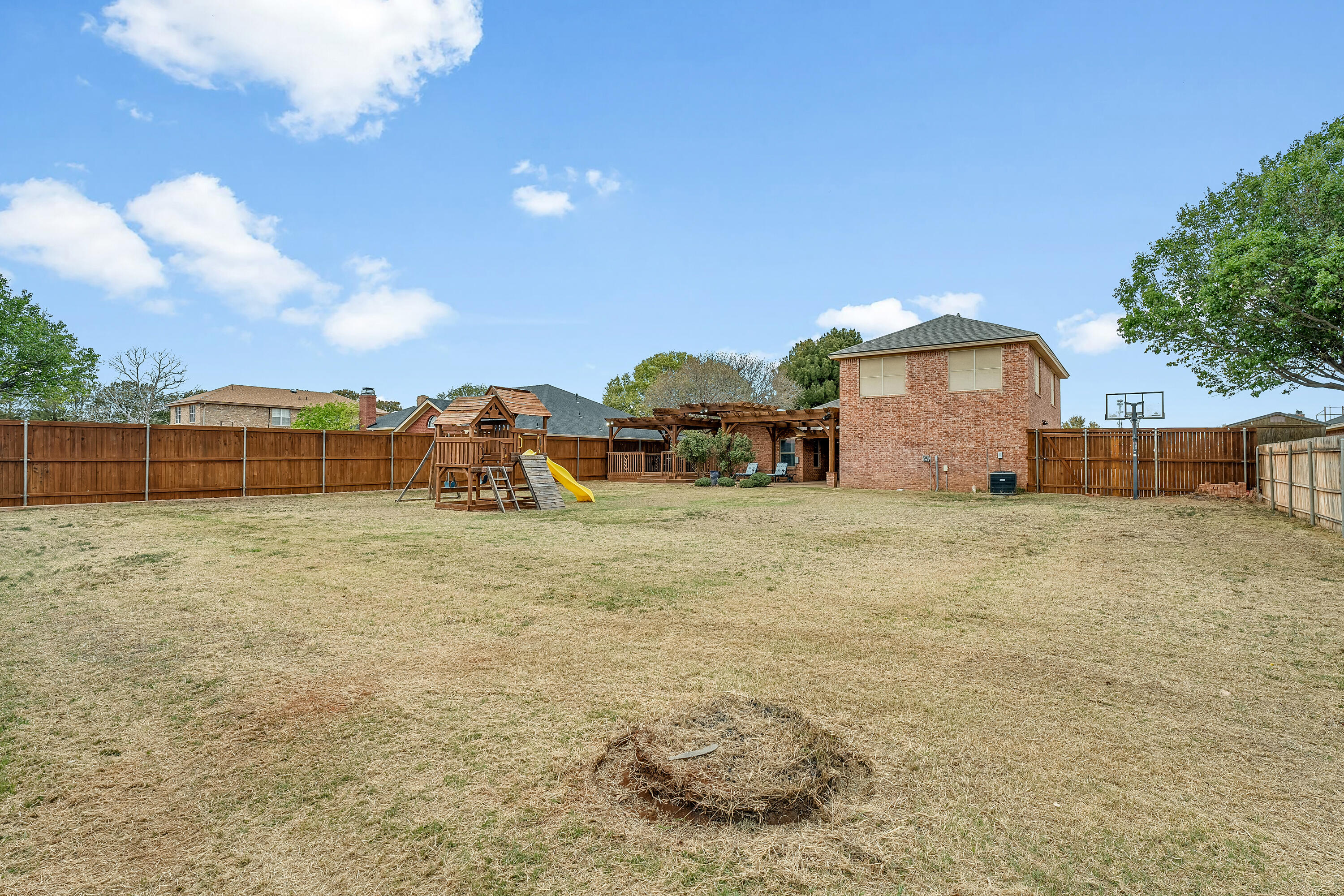 6903 87th Street Lubbock, TX 79424 - Photo 35 of 35 a view of a yard with wooden fence