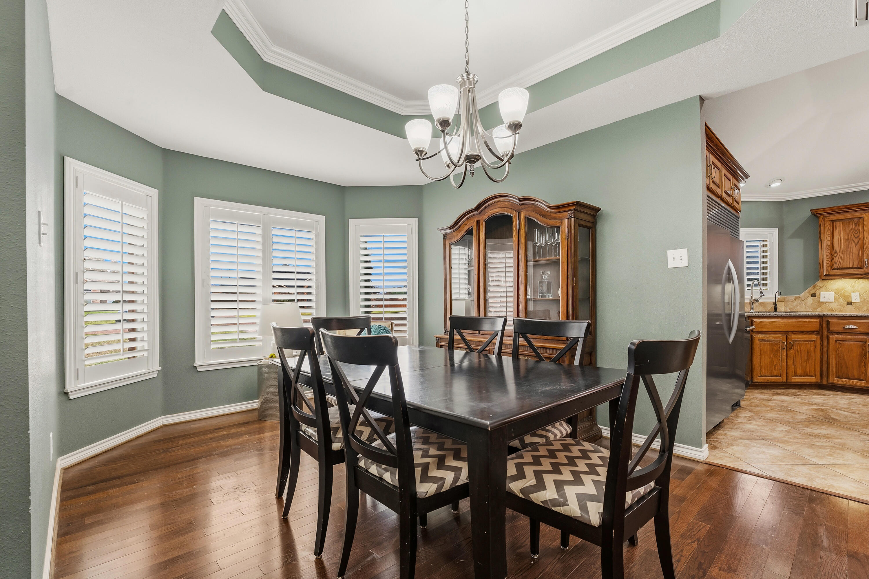 6903 87th Street Lubbock, TX 79424 - Photo 8 of 35 a view of a dining room with furniture window and wooden floor