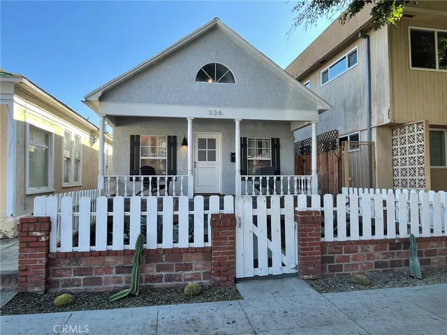 a view of a house with wooden fence