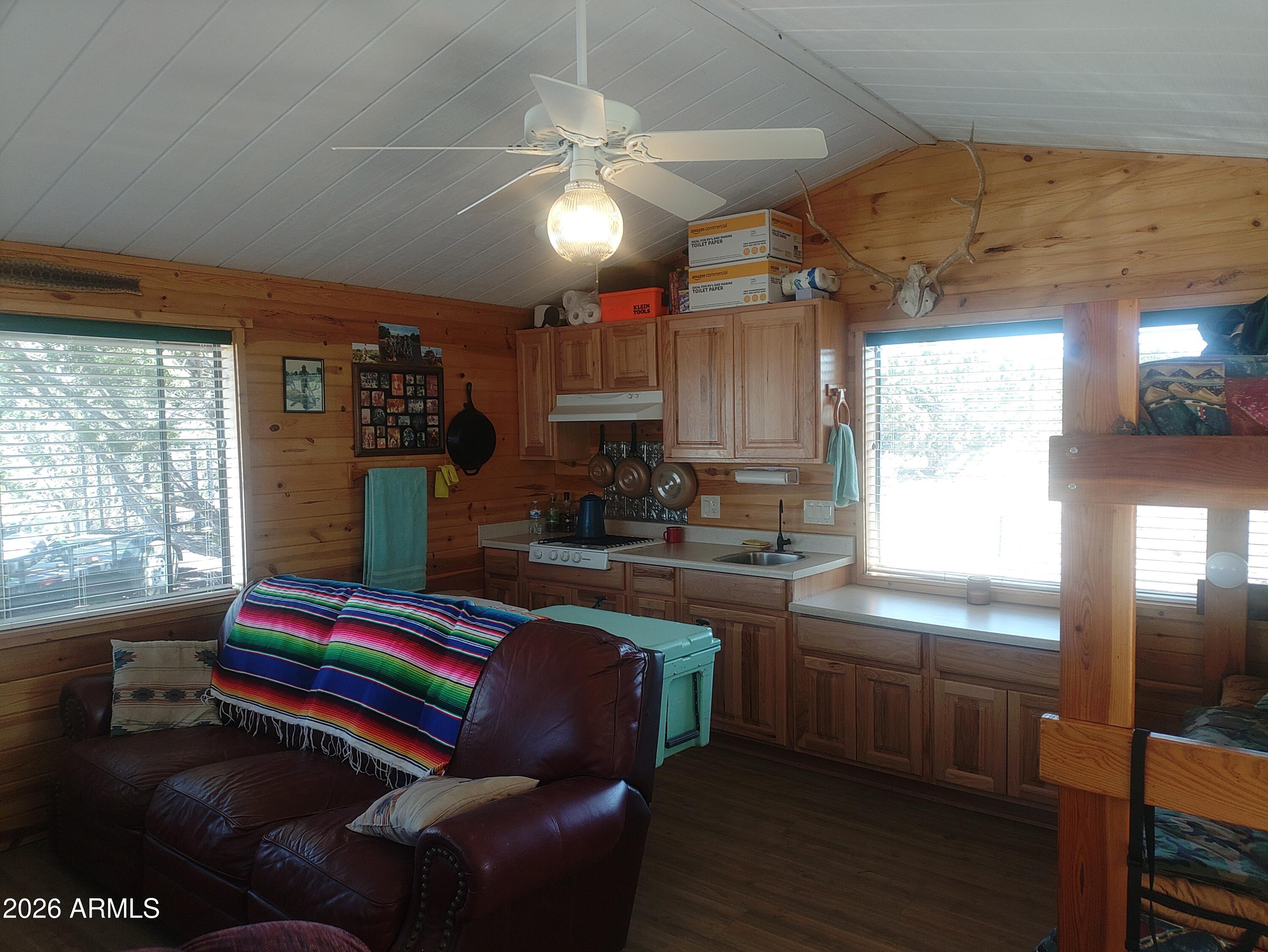 1417 Buffington Hill Road Heber, AZ 85928 - Photo 9 of 17 a living room with kitchen island granite countertop furniture and a fireplace