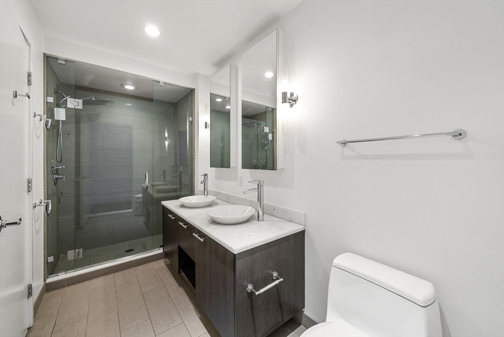 110 Stuart Street, Unit 19H Boston, MA 02116 - Photo 11 of 24 a bathroom with a sink a toilet and shower