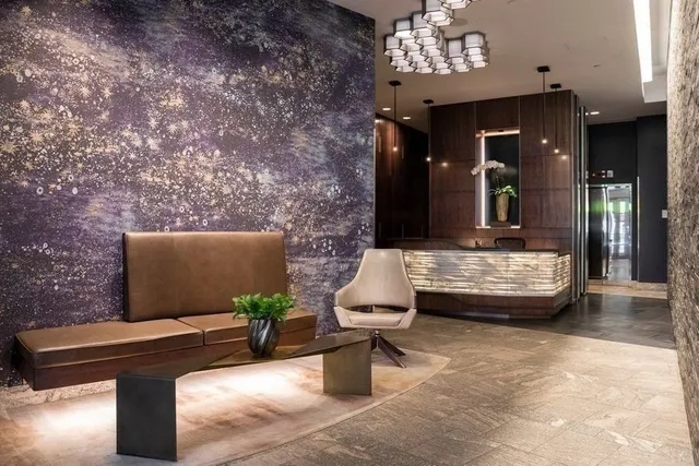 a lobby with furniture and floor to ceiling window