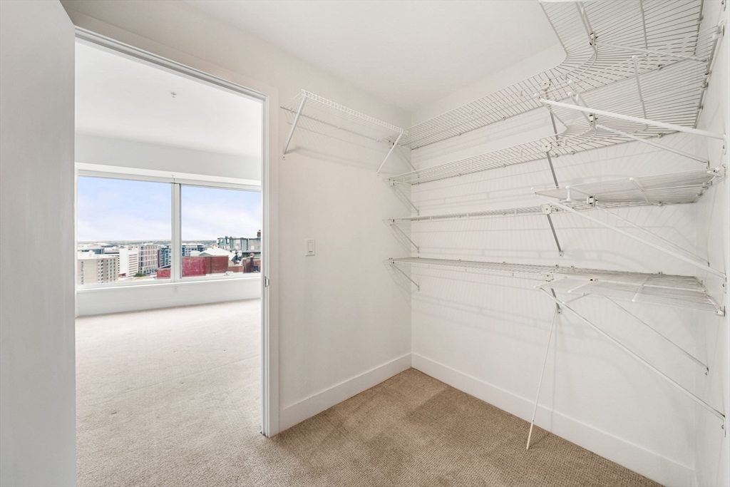 110 Stuart Street, Unit 19H Boston, MA 02116 - Photo 9 of 24 a view of a livingroom with wooden floor and a ceiling fan