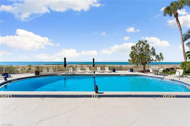 a view of a swimming pool and an outdoor seating