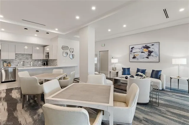 a large living room with stainless steel appliances kitchen island granite countertop furniture and a view of kitchen