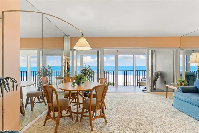 a dining room with furniture a garden and patio