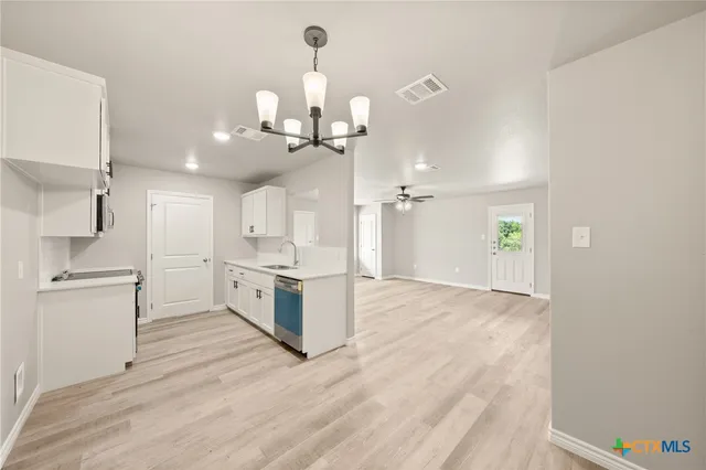 a kitchen with a sink and cabinets