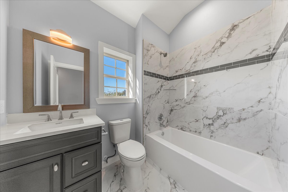 217 Gato Road Cedar Creek, TX 78612 - Photo 24 of 40 a bathroom with a bathtub sink vanity mirror and toilet