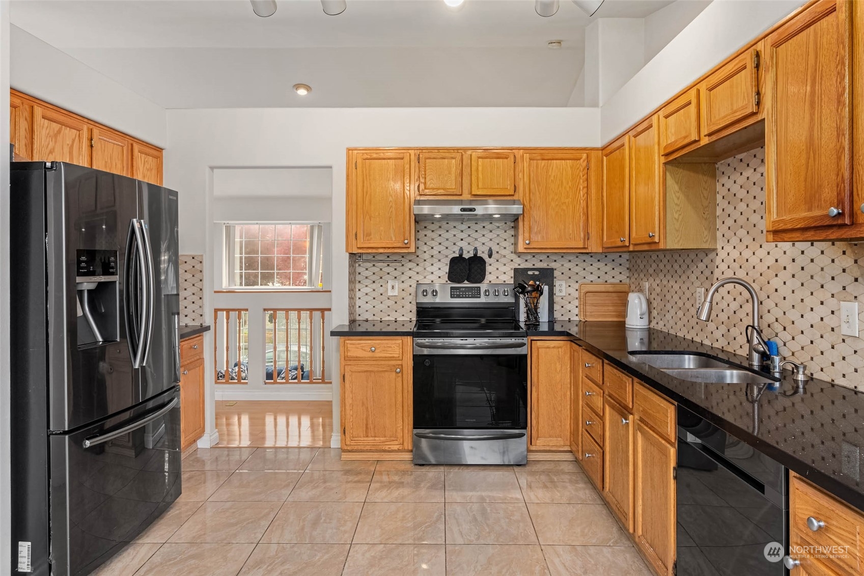 9031 West Mall Drive Everett, WA 98208 - Photo 11 of 32 a kitchen with stainless steel appliances granite countertop a refrigerator stove top oven and sink