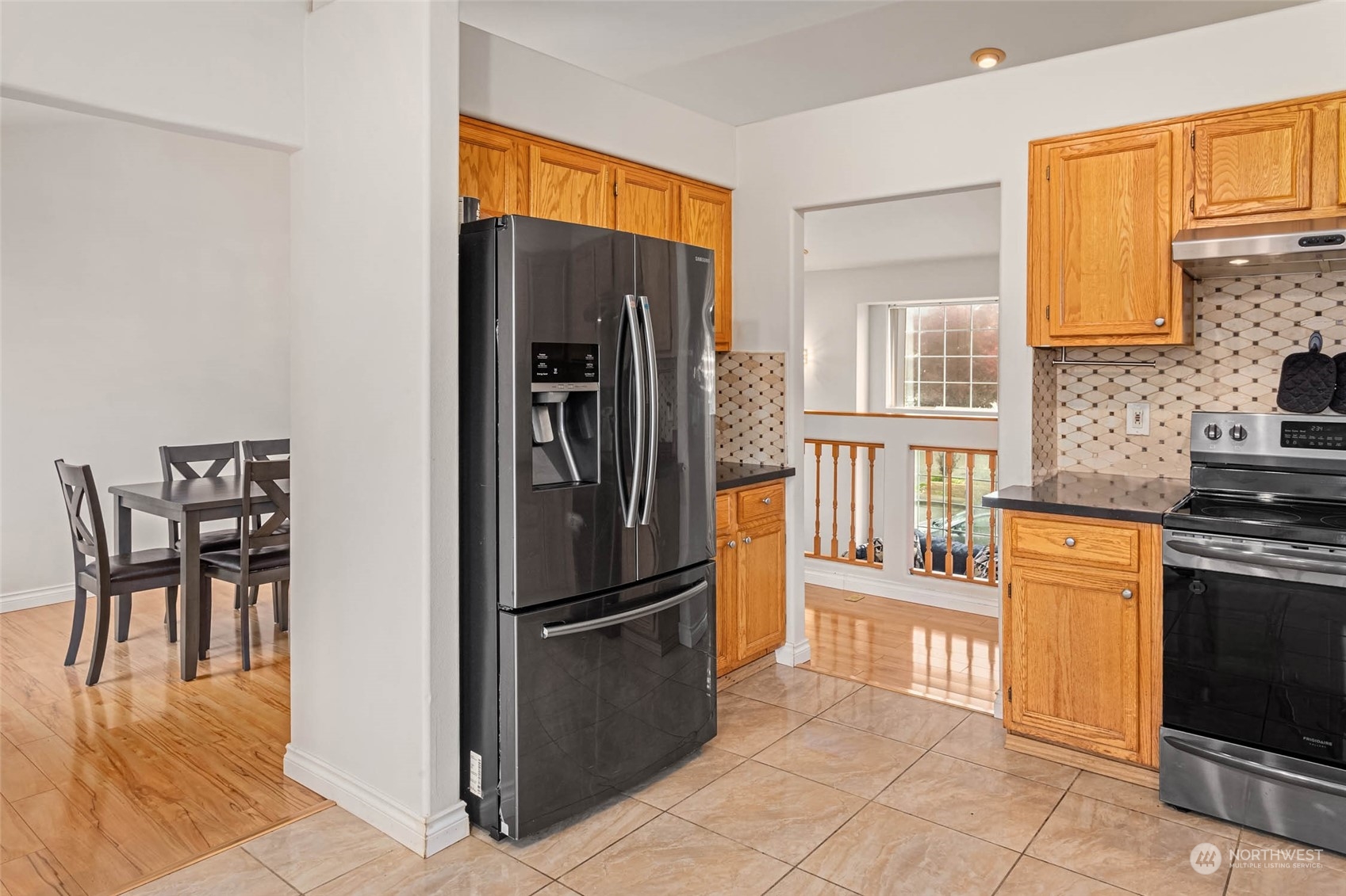 9031 West Mall Drive Everett, WA 98208 - Photo 12 of 32 a kitchen with stainless steel appliances granite countertop a refrigerator and a stove top oven