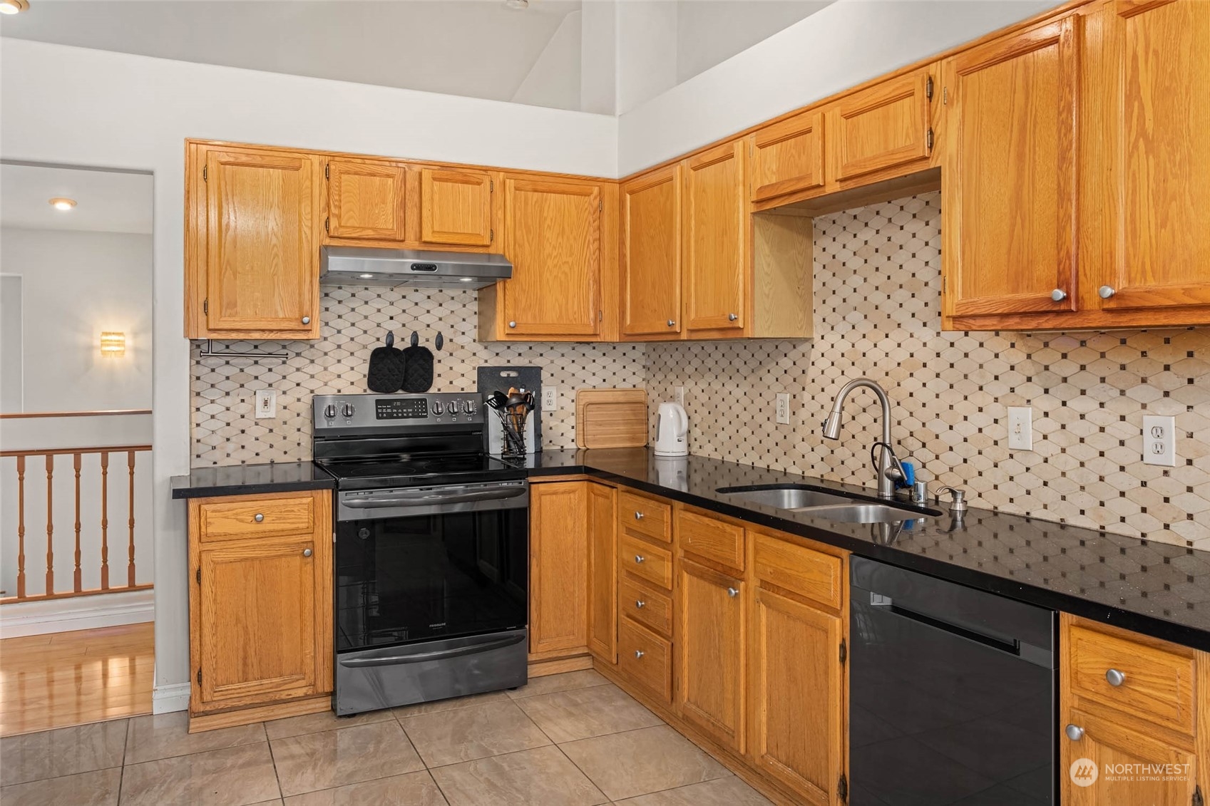 9031 West Mall Drive Everett, WA 98208 - Photo 13 of 32 a kitchen with stainless steel appliances granite countertop a stove a sink and a microwave